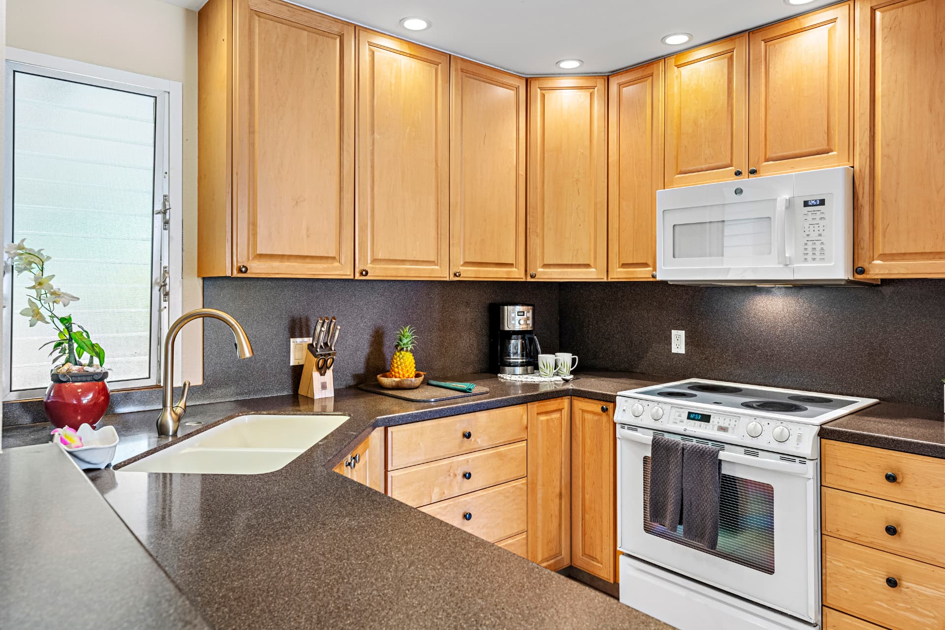 Suite F-201 full kitchen with stove, microwave and coffee maker