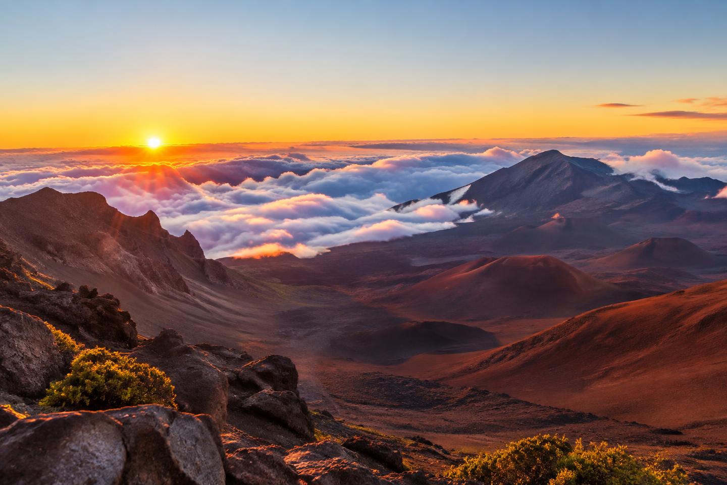 Scenic guide illustration of sunrise over a volcanic crater and clouds